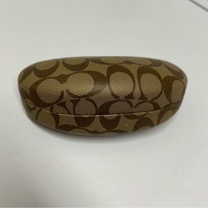 Coach hard clam shell glasses case in a brown color